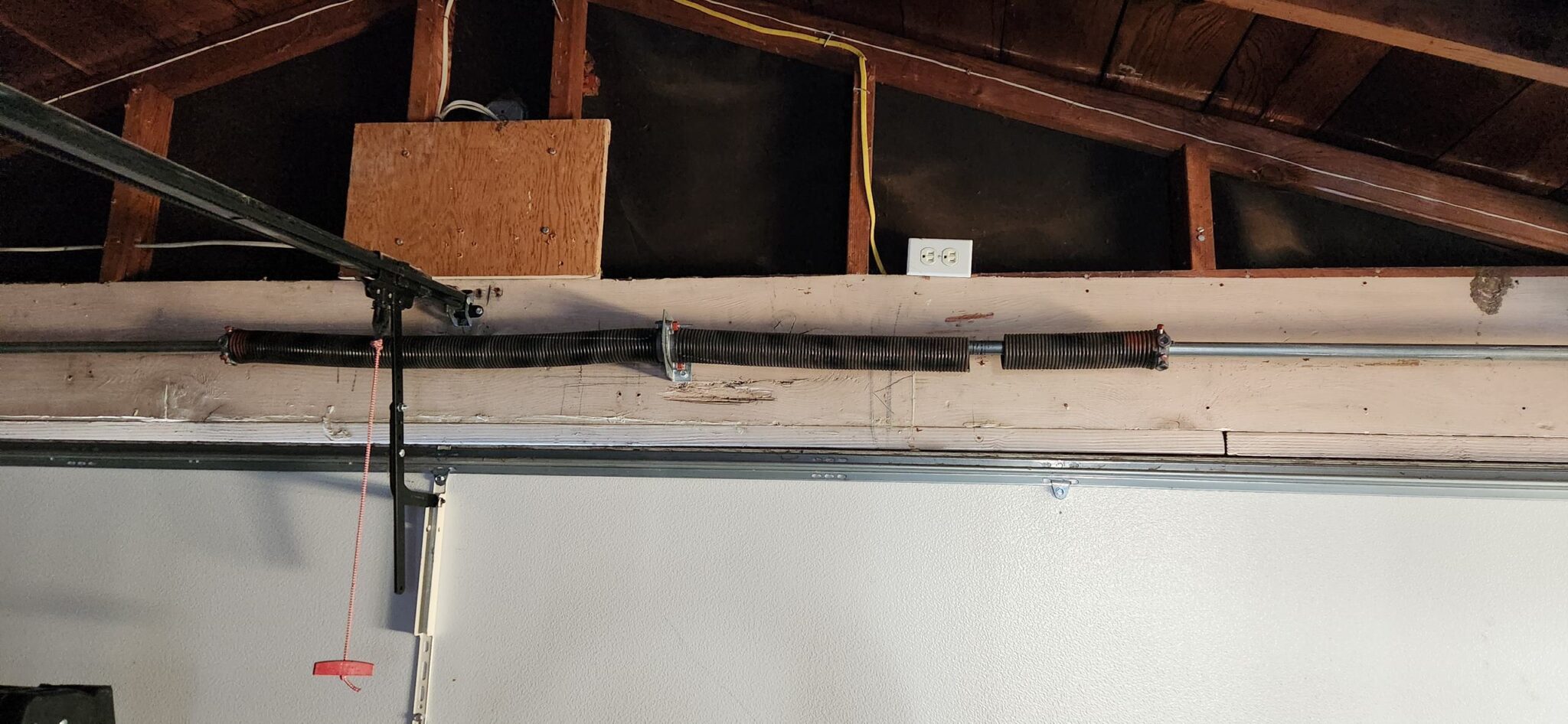 Close-up of a broken garage door spring