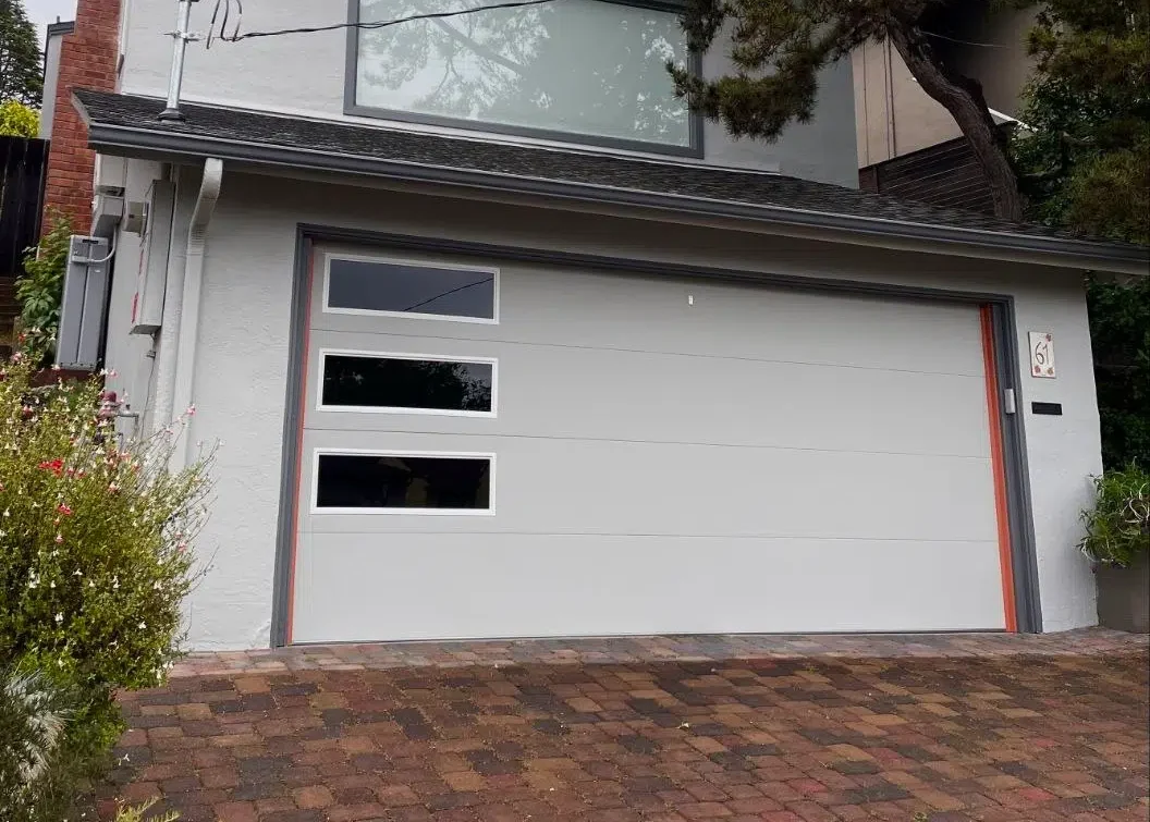 Modern skyline flush garage door with tinted glass in the Oakland hills