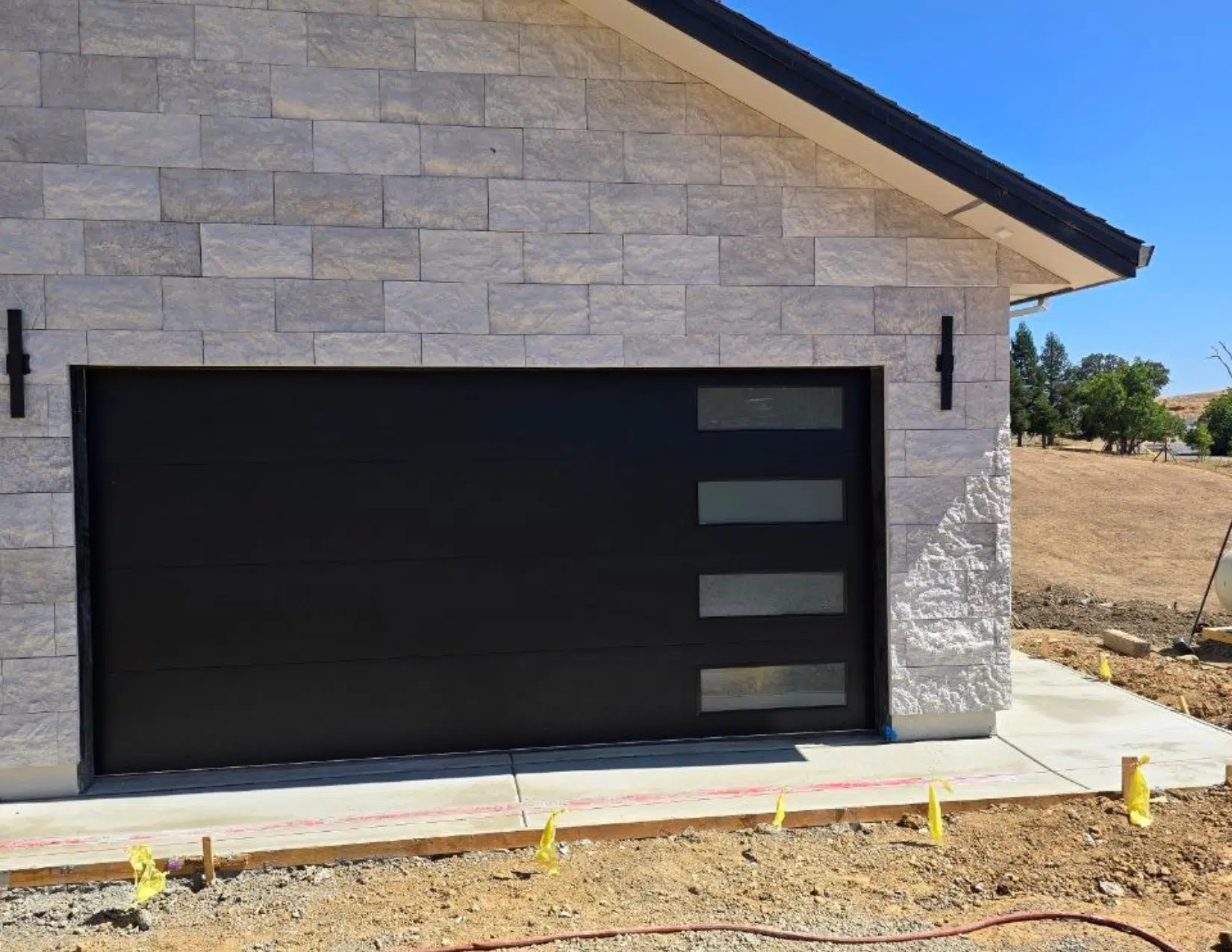 Black flush panel garage door installation