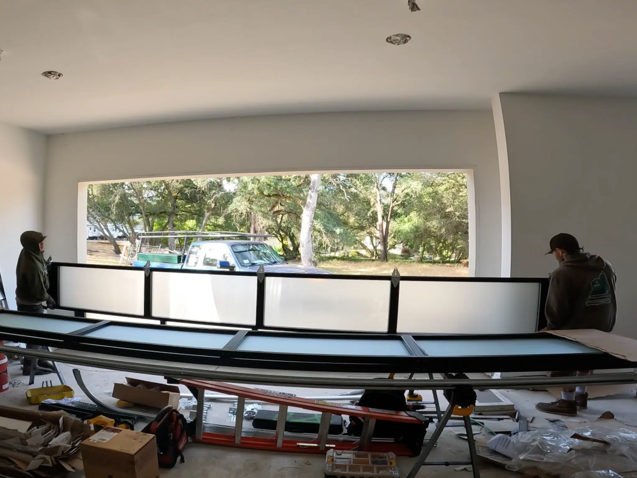 Dustin Cantu installing a garage door